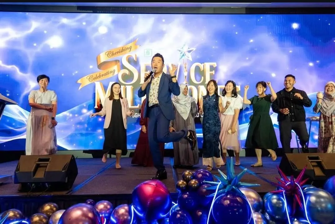 James Yang on stage with honourees at a service milestones celebration