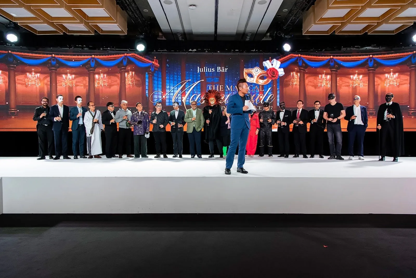 James Yang hosting The Magical Masquerade for Julius Baer, guests in masks on stage